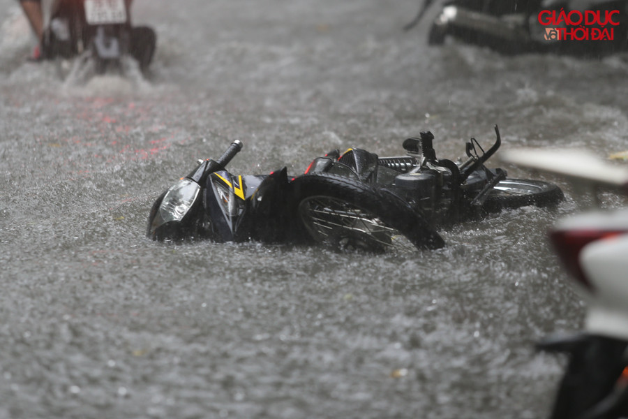 Nhiều xe đỗ trên vỉa hè bị sóng do các phương tiện đi qua tạt làm đổ