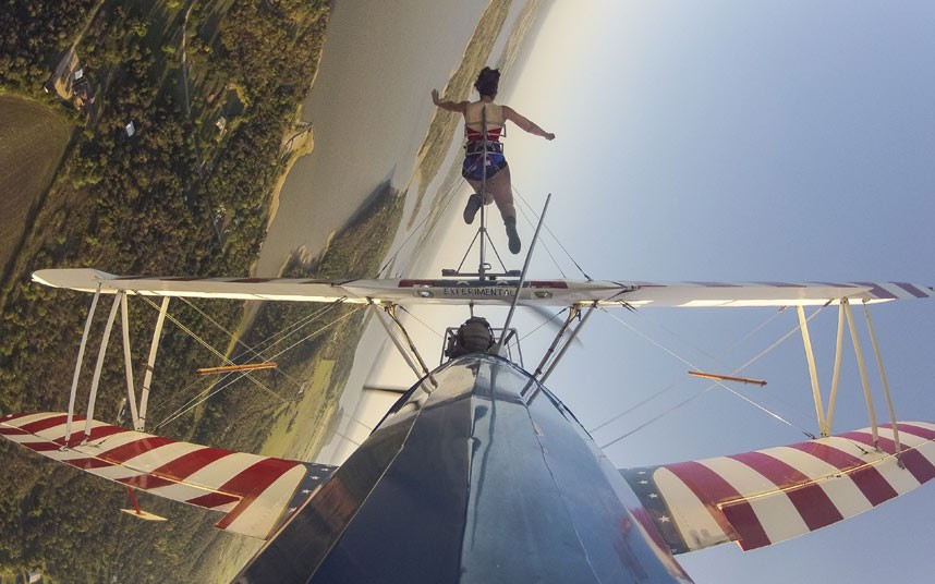 Daredevil wing walker Ashley Battles holds the world record for remaining on the wings of a plane for a staggering four hours and two minutes. The 29-year-old, who has clocked up over 100 flights so far in her career, performs with no safety net and is simply strapped onto a rack bolted to the wing span.