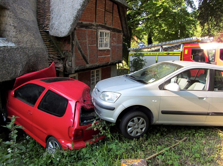 A driver ploughed into a thatched cottage and ended up in the kitchen after colliding with another motorist - whose car then followed the other one in