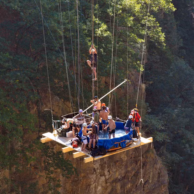 A group of adrenaline junkies suspend themselves 150 metres from the ground in a jacuzzi, while hanging from the New Gueuroz Bridge in Switzerland