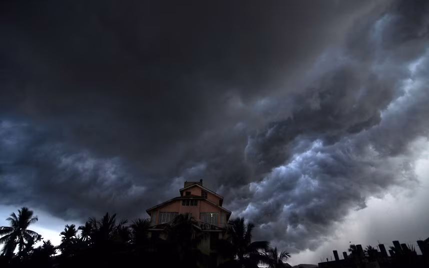 Dark rain clouds cover the sky over Guwahati, capital of India’s north-eastern Assam state