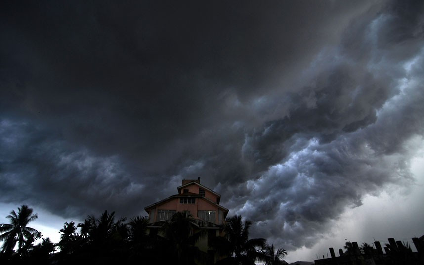 Dark rain clouds cover the sky over Guwahati, capital of India’s north-eastern Assam state