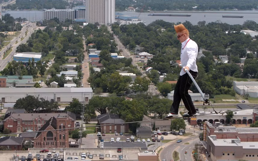 Comic daredevil Bello Nock walks on a high wire strung across the front of the Beau Rivage Resort & Casino in Biloxi, Mississippi