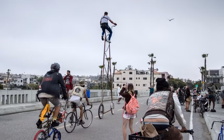 Richie Trimble rides his 14.5ft high bicycle through the streets of L.A. during the sixth CicLAvia cycle event in Los Angeles. Richie built the creation in just 12 hours after being challenged by a friend he used an old Huffy beach cruiser, metal tubing, a brake wheel set and single speed bicycle chains. He then took it for a spin on the streets of L.A. where 150,000 took to the streets on bikes. The tall bicycle - nicknamed Stoopid Tall by Richie - is not road legal and crucially doesn