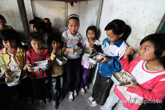 The students are having a meal of rice in Qiaoyin village of Fengshan prefecture, one of China’s state-level poor counties in Hechi city in South China’s Guangxi Zhuang autonomous region, May 19, 2011