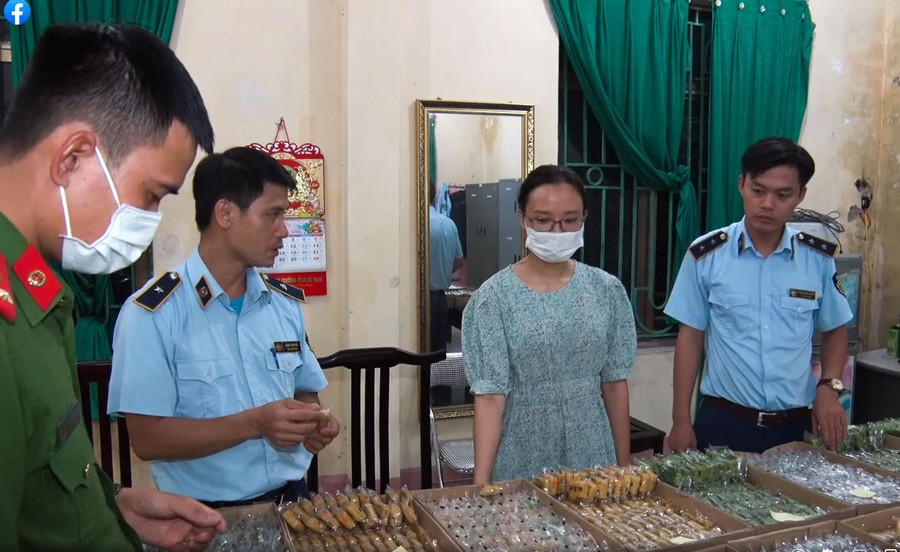 Phạm Thị Phụng cùng số bánh không rõ nguồn gốc bị cơ quan chức năng thu giữ.