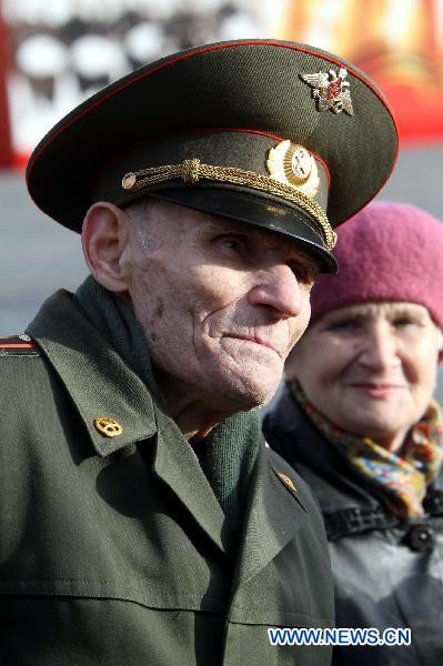 A World War II veteran watches a military parade 