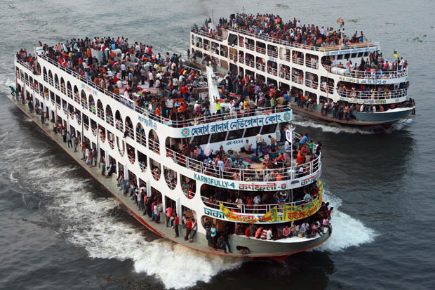 Passengers travel home in overcrowded ferries along the Buriganga river in Dhaka, Bangladesh