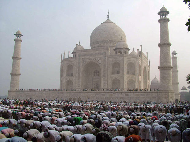 The historic Taj Mahal is seen as Indian Muslims perform congregational Eid al-Adha morning prayers in Agra