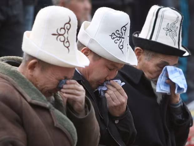 Men attend prayers during Kurban-Ait, also known as Eid al-Adha, at a square in Bishkek, Kyrgyzstan