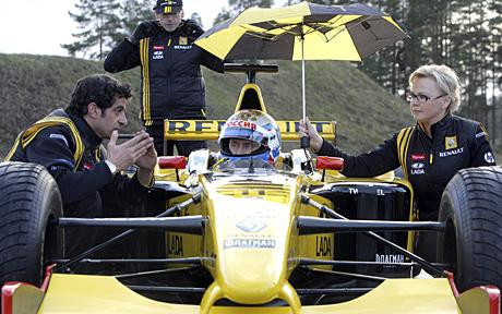 Russia’s Prime Minister Vladimir Putin listens to instructions from Renault Formula One team members before test driving the car at a racing track in Leningrad