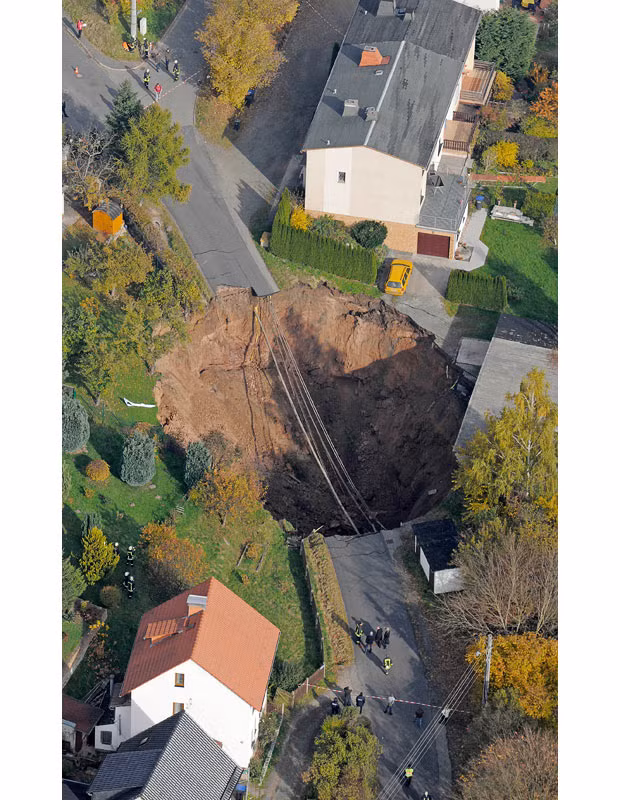An aerial photo shows a massive crater that appeared in a residential street in Schmalkalden, Germany, on 1 November 2010. The cause of the landslide is as yet unclear. Residents were evacuated from 23 buildings. Nobody was injured...