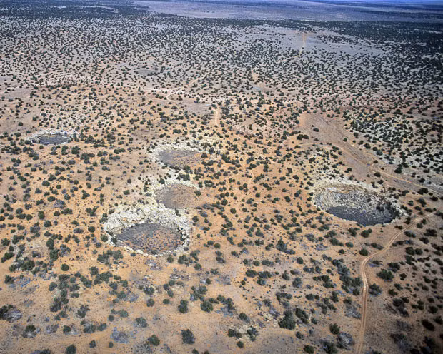 An aerial view of high desert Karst topography near Winslow, Arizona shows several sinkholes, probably caused by the collapse of caves