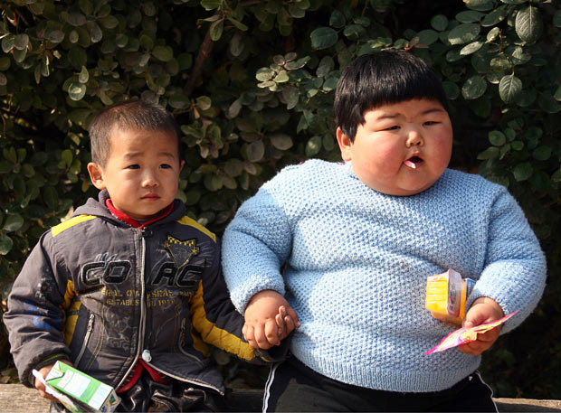 Fan Sijia, an obese two-year-old girl who weighs as much as adult woman, plays with a neighbourhood boy who is about the same age as her in Taocun town, Shanxi province, China. She was born in January 2008 and now weighs 45 kilograms