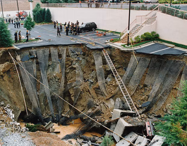 Police securing an enormous sinkhole in Atlanta, Georgia, in June 1993