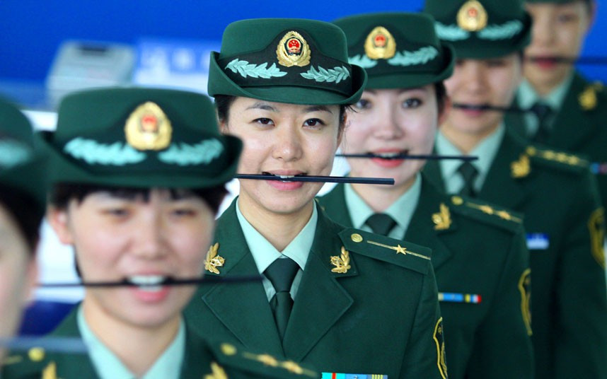 Custom officials take part in a ’how to smile’ course in Dalian, Liaoning Province, China