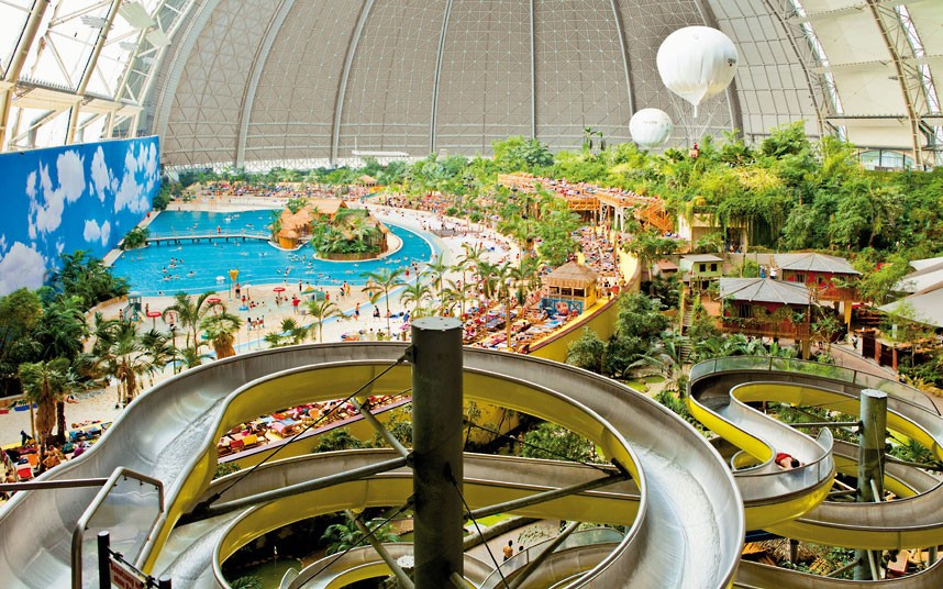 A tropical island paradise resort has been built inside an old airship hangar so big could easily fit eight football pitches in it. A sandy beach, spa, waterfall, whirlpools and water slides are just a few of the attractions . The indoor tropical island, located in Brandenburg, Germany, boasts an air temperature of 26 degrees, with water being 28C in the Tropical Sea and 32C in the Bali Lagoon. It is also host to the world’s biggest indoor rainforest, which features over 50,000 plants.