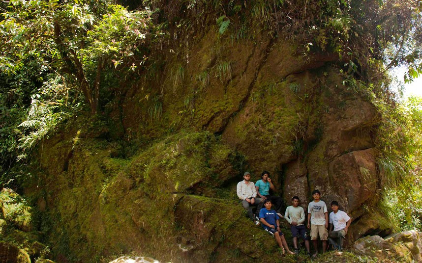 Spanish explorer Diego Cortijo (top L) poses with Amarakaeri Indians and Peruvian guides participating in Expedition Gutioli 2012, next to a rock which resembles the face of an Inca in the Amazon rainforest of southeastern Peru. Cortijo couldn’t determine if the image was carved in existing rock or if it is a natural coincidence.
