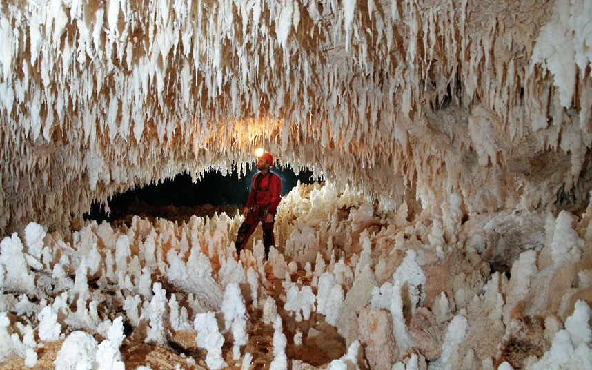 A caver stands in a chamber of stalagmites and stalactites in New Britain, Papua New Guinea. A French-Swiss team has made it their mission to explore the miles of chambers and sinkholes beneath the Nakanai Mountains. The latest expeditions were captured by French photographer Philip Bence, 43, who described it as an ’incredible and unforgettable adventure’. 