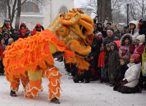 People watch lion dance during a celebration for the Chinese Spring Festival, or lunar New Year, in Stockholm, capital of Sweden, on Feb. 13, 2010