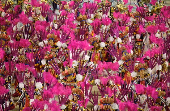 Dancers perform on an Uniao da Ilha samba school float during carnival parade at the Sambadrome, in Rio de Janeiro, Brazil 