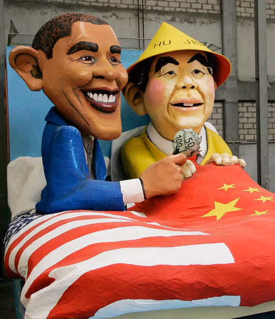 Another Carnival float in Cologne shows the American President in bed with Chinese Prime Minister Hu Jintao