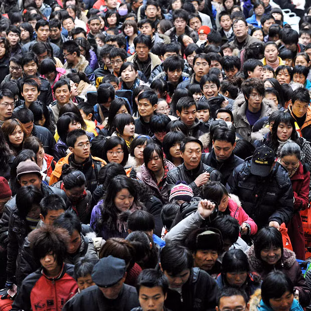 Passengers wait to board a train at a station in Hefei, east China’s Anhui province. More than 150 million people are expected to return to their home towns and villages for the Lunar New Year which falls on February 14