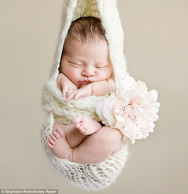 Suspended animation: But at least I’ve got a posy for my toes Read more: http://www.dailymail.co.uk/news/article-1251841/The-incredible-pictures-snoozing-newborns-taken-babies-10-days-old.html#ixzz0frLmO4qE