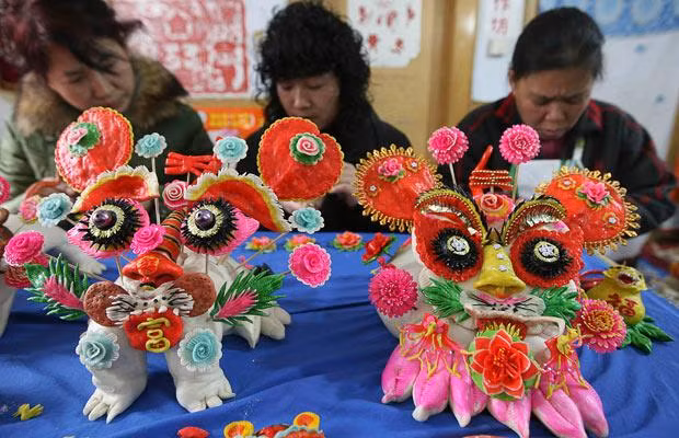 Women make steamed bread in the shape of tigers to celebrate upcoming Chinese Lunar New Year, in Wanrong County, Shanxi province, China