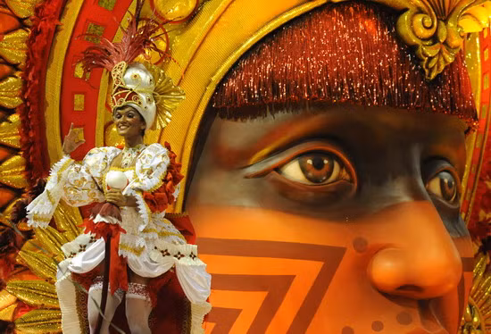 A member of the Salgueiro samba school performs on a float at the Sambodrome during the first night of Rio de Janeiro’s famed carnival parade