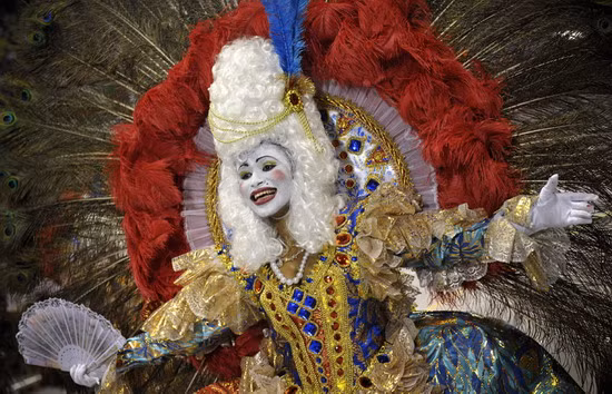 A performer from the Academicos do Tucuruvi samba school parade in a float at the Sambadrome as part of Carnival celebrations in Sao Paulo, Brazil