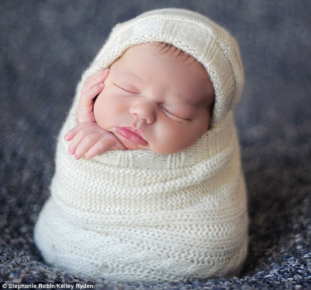 It’s a wrap: Lulled to sleep with a swaddling song Read more: http://www.dailymail.co.uk/news/article-1251841/The-incredible-pictures-snoozing-newborns-taken-babies-10-days-old.html#ixzz0frLA6tAx