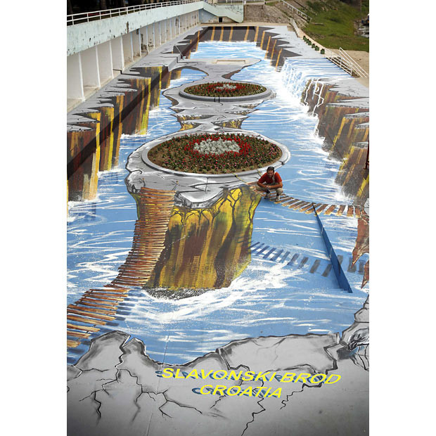 Croatian artist Philip Mrvelj poses with the largest 3D image in the world, which he created in Slavonski Brod, Croatia. He enters into the Guinness Book of Records with this picture measuring 1,300 m2.