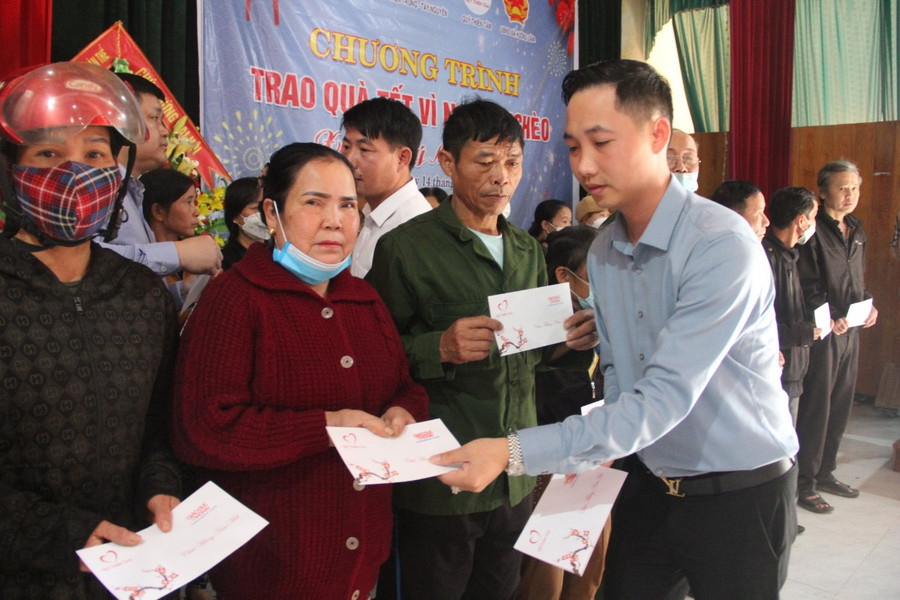 Đại diện Công ty Cổ phần tập đoàn đầu tư DNT trao quà Tết cho các hộ dân.