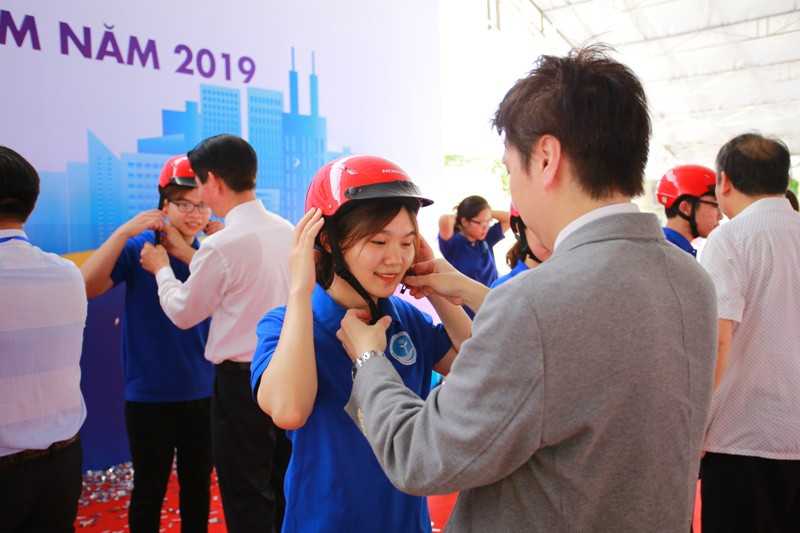 Đại diện Honda Việt Nam hướng dẫn đội mũ bảo hiểm cho các bạn sinh viên