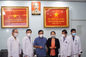 TS.BS Nguyễn Tri Thức lì xì chúc mừng hai vợ chồng bệnh nhân B. Ảnh: BV.