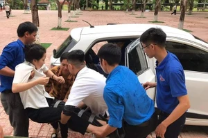 Thí sinh Bùi Vân Thư được taxi 0 đồng chở tới điểm thi Trường THPT Nguyễn Sỹ Sách (Nghệ An) và đội thanh niên tình nguyện dùng cáng đưa lên phòng thi. Ảnh: Nhữ Tiến.