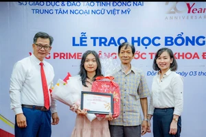 Ông Nguyễn Quốc Khánh, Chủ tịch kiêm Tổng Giám Đốc tập đoàn giáo dục Việt Mỹ(trái) trao học bổng cho thủ khoa của tỉnh. 