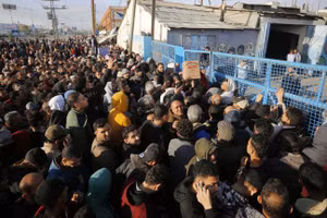 Người Palestine xếp hàng nhận bột mì do cơ quan tị nạn LHQ phân phát tại Deir Al Balah, Gaza, ngày 7/12/2023