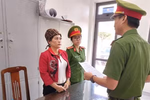 Công an tống đạt quyết định khởi tố vụ án, khởi tố bị can. Ảnh: Công an. 