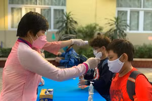 Học sinh TP.HCM được kiểm tra thân nhiệt trước khi vào trường trong. Ảnh minh hoạ 