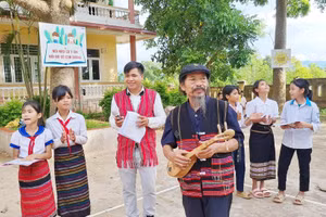 Nghệ nhân Ưu tú Kray Sức (cầm đàn) đang hướng dẫn các em học làn điệu dân ca. 