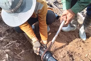 Những người thợ cố định khớp nối đường dây dẫn nước dài hàng km băng rừng đưa nước về làng Cheng Toong.