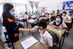 Giáo viên Malaysia đo thân nhiệt cho học sinh vào ngày 15/7/2020.