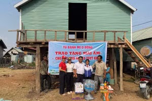 Thầy Vũ Văn Tùng (ở giữa) bàn giao mái ấm, vật dụng thiết yếu cho em Nay H’Lại và gia đình. Ảnh: Nhân vật cung cấp