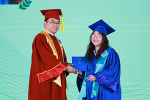 PGS.TS Bùi Xuân Hải - Phó hiệu trưởng trao bằng cho 1 tân cử nhân 