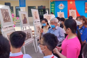 Học sinh Trường THCS Nguyễn Văn Linh (Hòa Vang) nghe họa sĩ - nhà điêu khắc Phạm Hồng - nhân chứng trực tiếp tham gia chiến đấu tại chiến trường khu V kể chuyện tại triển lãm Ký họa chiến trường.