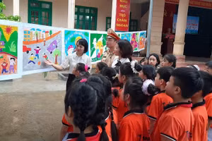 Cô giáo Hoàng Trà My - người sáng lập CLB Mỹ thuật nhà trường đang giới thiệu với khách tham quan tác phẩm của các em học sinh