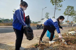 Học sinh Trường THCS Lê Lợi dọn vệ sinh để bảo vệ môi trường. (Ảnh: Dung Nguyễn)