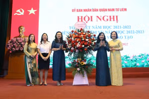 Phó Giám đốc Sở GD&ĐT Hà Nội Trần Lưu Hoa (thứ 3 từ trái sang) tặng hoa chúc mừng thành tích của ngành GD&ĐT quận Nam Từ Liêm.